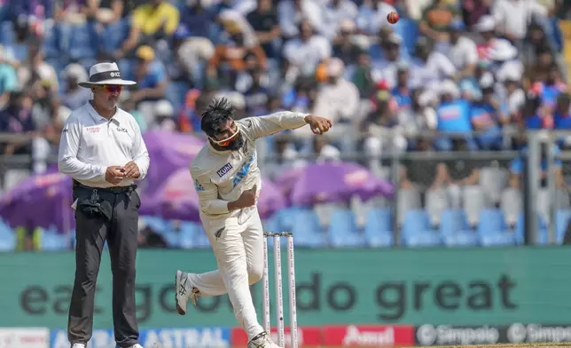 New Zealand's Aijaz Patel bowls a delivery during the third day of the third cricket test match between India and New Zealand at Wankhede Stadium, in Mumbai, India, Sunday, Nov. 3, 2024.(AP Photo/Rajanish Kakade)