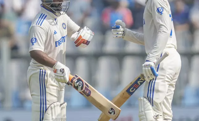 India's Rishab Pant, left, and Shubman Gill bump fists during the second day of the third cricket test match between India and New Zealand at Wankhede Stadium, in Mumbai, India, Saturday, Nov. 2, 2024.(AP Photo/Rajanish Kakade)