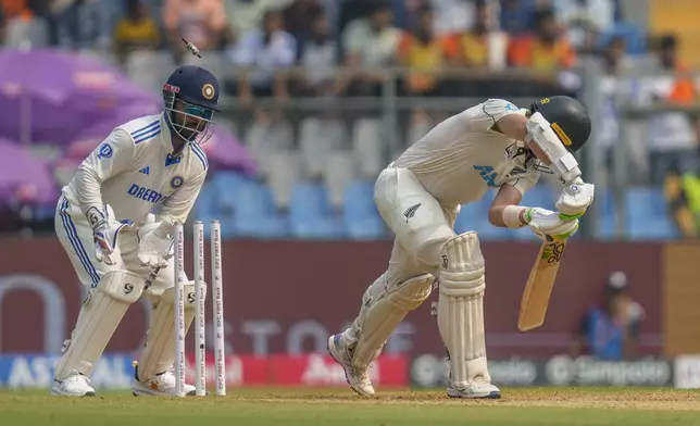 New Zealand's captain Tom Latham is bowled out during the first day of the third cricket test match between India and New Zealand at Wankhede Stadium, in Mumbai, India, Friday, Nov. 1, 2024.(AP Photo/Rajanish Kakade)