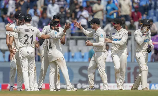 New Zealand's players celebrate their team's win against India at the end of their third and final Test cricket match at Wankhede Stadium, in Mumbai, India, Sunday, Nov. 3, 2024.(AP Photo/Rajanish Kakade)