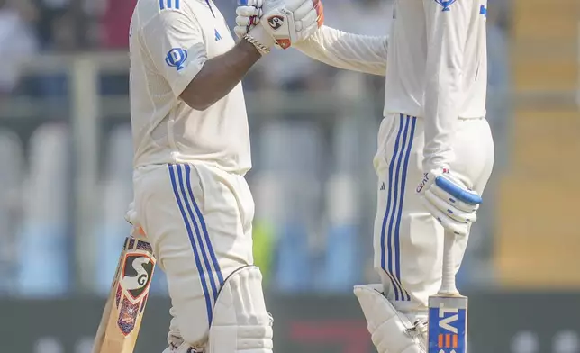 India's Rishab Pant, left, celebrates scoring fifty runs with his teammate Shubman Gill during the second day of the third cricket test match between India and New Zealand at Wankhede Stadium, in Mumbai, India, Saturday, Nov. 2, 2024.(AP Photo/Rajanish Kakade)