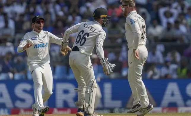 New Zealand's Glenn Phillips, right, celebrates with teammates after the dismissal of India's Yashasvi Jaiswal during the third day of the third cricket test match between India and New Zealand at Wankhede Stadium, in Mumbai, India, Sunday, Nov. 3, 2024.(AP Photo/Rajanish Kakade)