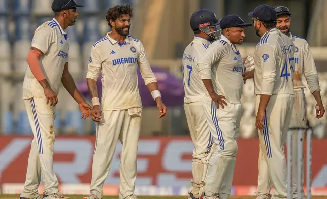 India's Ravindra Jadeja, second left, celebrates with teammates after the dismissal of New Zealand's Ish Sodhi during the second day of the third cricket test match between India and New Zealand at Wankhede Stadium, in Mumbai, India, Saturday, Nov. 2, 2024.(AP Photo/Rajanish Kakade)