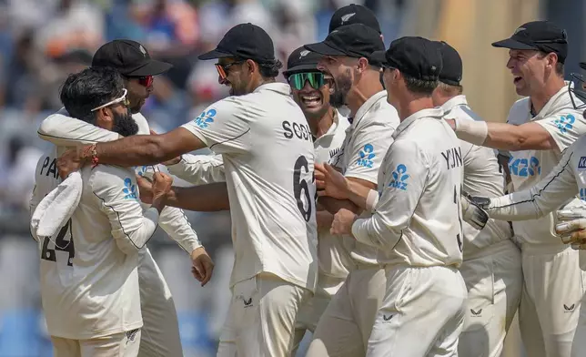 New Zealand's players celebrates the dismissal of India's Rishab Pant during the third day of the third cricket test match between India and New Zealand at Wankhede Stadium, in Mumbai, India, Sunday, Nov. 3, 2024.(AP Photo/Rajanish Kakade)