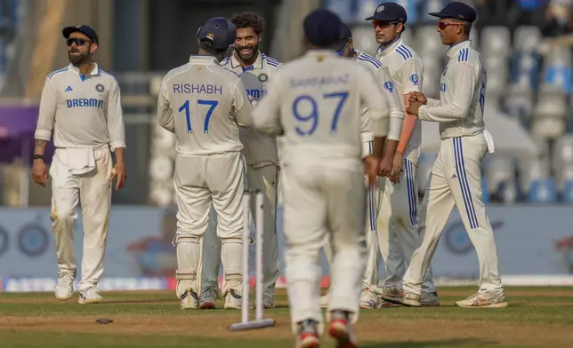 India's Ravindra Jadeja, third left without cap, celebrates with teammates after the dismissal of New Zealand's Tom Blundell during the second day of the third cricket test match between India and New Zealand at Wankhede Stadium, in Mumbai, India, Saturday, Nov. 2, 2024.(AP Photo/Rajanish Kakade)