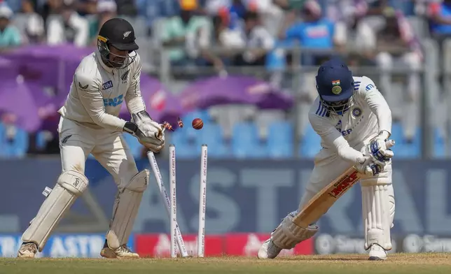 India's Akash Deep is is bowled out by New Zealand's Glenn Phillips during the third day of the third cricket test match between India and New Zealand at Wankhede Stadium, in Mumbai, India, Sunday, Nov. 3, 2024.(AP Photo/Rajanish Kakade)