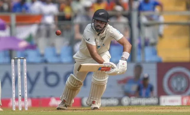 New Zealand's Daryl Mitchell plays a shot during the first day of the third cricket test match between India and New Zealand at Wankhede Stadium, in Mumbai, India, Friday, Nov. 1, 2024.(AP Photo/Rajanish Kakade)