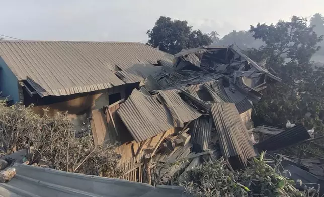 In this photo released by the Indonesian National Search and Rescue Agency (BASARNAS), a house is seen damaged by the eruption of Mount Lewotobi Laki-Laki in East Flores, Indonesia on Monday, Nov. 4, 2024. (BASARNAS via AP)