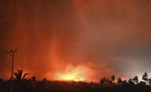 In this photo made available by Indonesia's Center for Volcanology and Geological Disaster Mitigation Agency (PVMBG) of the Ministry of Energy and Mineral Resources, the sky glows from the eruption of Mount Lewotobi Laki-Laki early Monday, Nov. 4, 2024, in East Flores, Indonesia. (PVMBG via AP)