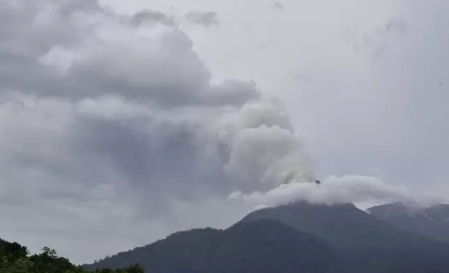 FILE - Mount Lewotobi Laki-Laki spews volcanic materials from its crater during an eruption in East Flores, Indonesia, Sunday, Jan. 14, 2024. (AP Photo/Andre Kriting, File)