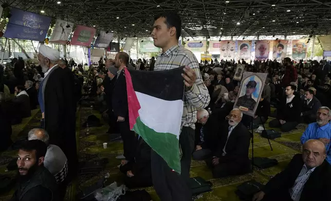 An Iranian worshipper holds a Palestinian flag during Friday prayer ceremony at the Tehran University campus, in Tehran, Iran, Friday, Nov. 8, 2024. (AP Photo/Vahid Salemi)