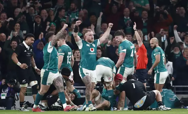 Ireland's Josh van der Flier's teammates react as he scores try during the the Autumn Nations series rugby union match between Ireland and New Zealand at the Aviva Stadium in Dublin, Ireland, Friday, Nov. 8, 2024. (AP Photo/Peter Morrison)