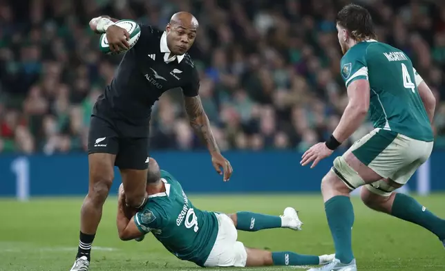 New Zealand's Mark Tele'a,, left, is tackled by Ireland's Jamison Gibson-Park, during the the Autumn Nations series rugby union match between Ireland and New Zealand at the Aviva Stadium in Dublin, Ireland, Friday, Nov. 8, 2024. (AP Photo/Peter Morrison)