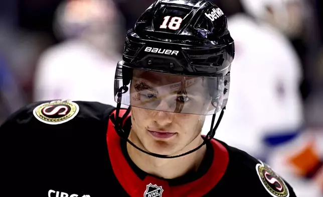 Ottawa Senators centre Tim Stutzle (18) returns to the game with sutures above his right eye after being hit in the face with a puck, during second period NHL hockey action against the New York Islanders in Ottawa, on Thursday, Nov. 7, 2024. (Justin Tang/The Canadian Press via AP)