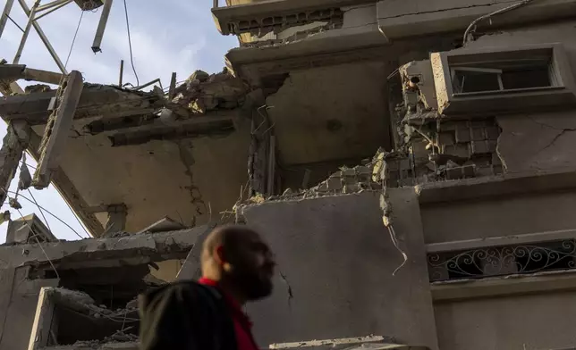 A man looks at damaged building after projectiles fired from Lebanon hit a home in Tira, central Israel, Saturday, Nov. 2, 2024. (AP Photo/Ariel Schalit)