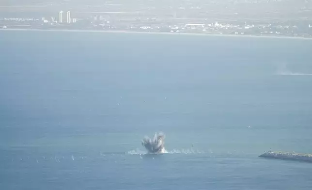 Rockets that were launched from Lebanon explode in the Mediterranean Sea as seen from Haifa, northern Israel, Friday, Nov. 8, 2024. (AP Photo/Francisco Seco)