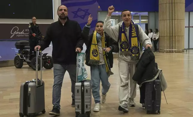 Maccabi Tel Aviv soccer fans arrive at Israel's Ben-Gurion International Airport on a flight from Amsterdam, where Israeli soccer fans were attacked following a match between the Israeli club and Ajax Amsterdam, in Lod, Israel, Friday, Nov. 8, 2024. (AP Photo/Tsafrir Abayov)