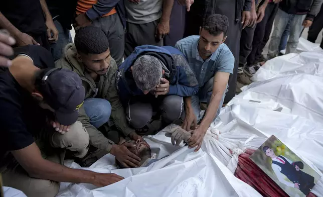 Palestinians mourn their relatives killed in the Israeli bombardment of the Gaza Strip at a hospital morgue in Deir al-Balah, Friday, Nov. 1, 2024. (AP Photo/Abdel Kareem Hana)