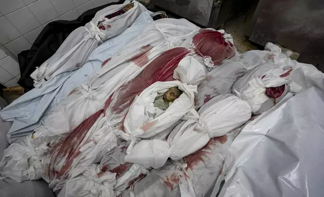 EDS NOTE: GRAPHIC CONTENT - Bodies of Palestinians killed in the Israeli bombardment of the Gaza Strip are seen at a hospital morgue in Deir al-Balah, Friday, Nov. 1, 2024. (AP Photo/Abdel Kareem Hana)