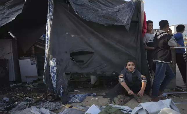 Palestinians gather at the site of an Israeli strike in the courtyard of the Al-Aqsa Hospital where displaced people live in tents, in Deir al-Balah, Gaza Strip, Saturday, Nov. 9, 2024. (AP Photo/Abdel Kareem Hana)