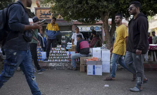 Palestinians sell items received in international aid shipments in an effort to collect cash in Deir al-Balah, Gaza, Wednesday, Nov. 13, 2024. (AP Photo/Abdel Kareem Hana)