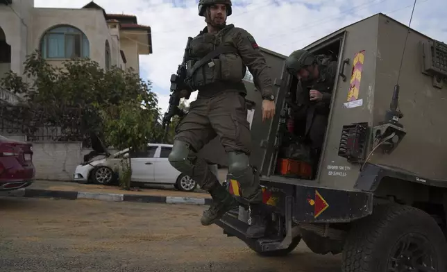 Israeli army investigators arrive at the site of the early morning attack of Israeli settlers, that left at least 18 burnt vehicles, on the outskirts of the West Bank city of al-Bireh Monday, Nov. 4, 2024. (AP Photo/Nasser Nasser)