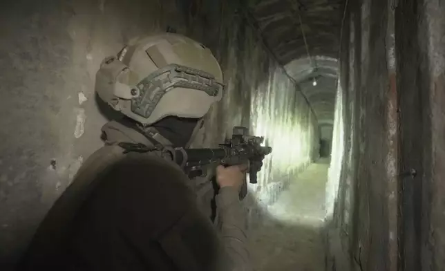 FILE - Israeli soldier shows the media an underground tunnel found underneath Shifa Hospital in Gaza City, Nov. 22, 2023. (AP Photo/Victor R. Caivano, File)