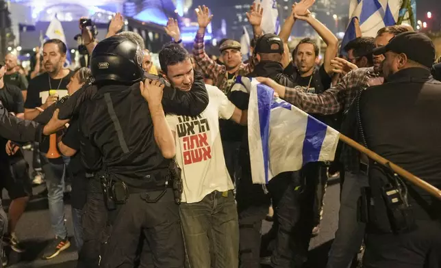 Israeli police try to push back protesters from a main road after Prime Minister Benjamin Netanyahu has dismissed his defense minister Yoav Gallant in a surprise announcement in Tel Aviv, Israel, Tuesday, Nov. 5, 2024. (AP Photo/Oded Balilty)