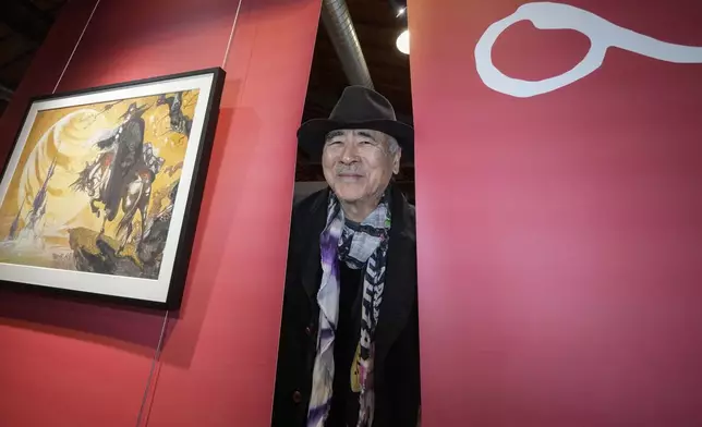 Artist Yoshitaka Amano poses during the press preview of the exhibition "Amano Corpus Animae", celebrating his 50-year-long career, at the Fabbrica del Vapore, in Milan, Italy, Tuesday, Nov. 12, 2024. (AP Photo/Luca Bruno)