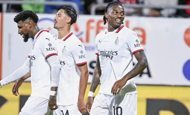 AC Milan's Rafael Leao, right, celebrates after scoring during the Italian Serie A soccer match between Cagliari and AC Milan at the Unipol Domus in Cagliari, Italy, saturday, Nov. 9, 2024. (Gianluca Zuddas/LaPresse via AP)