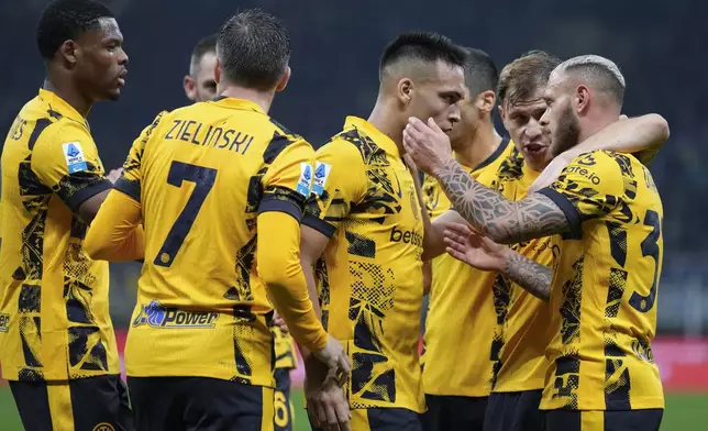 Inter Milan's Lautaro Martinez, center, celebrates with his teammates after he scored his side's first goal during the Serie A soccer match between Inter Milan and Venezia at the San Siro Stadium, in Milan, Italy, Sunday, Nov. 3, 2024. (AP Photo/Antonio Calanni)