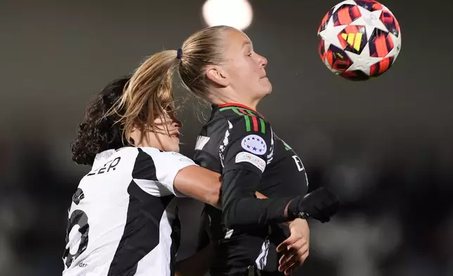 Arsenal's Frida Leonhardsen Maanum, right, and Juventus' Eva Schatzer vie for the ball during the women's Champions League soccer match between Juventus and Arsenal at the Vittorio Pozzo La Marmora Stadium in Biella, Italy, Tuesday, Nov. 12, 2024. (Fabio Ferrari/LaPresse via AP)