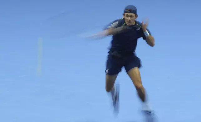 Australia's Alex de Minaur returns the ball to Italy's Jannik Sinner during their singles tennis match of the ATP World Tour Finals at the Inalpi Arena, in Turin, Italy, Sunday, Nov. 10, 2024. (AP Photo/Antonio Calanni)