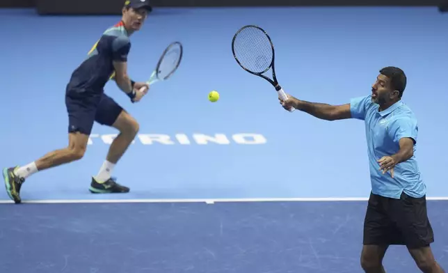 India's Rohan Bopanna, right, and Australia's Matthew Ebden return the ball to Italy's Simone Bolelli and Andrea Vavassori during their doubles tennis match of the ATP World Tour Finals at the Inalpi Arena, in Turin, Italy, Monday, Nov. 11, 2024. (AP Photo/Antonio Calanni)