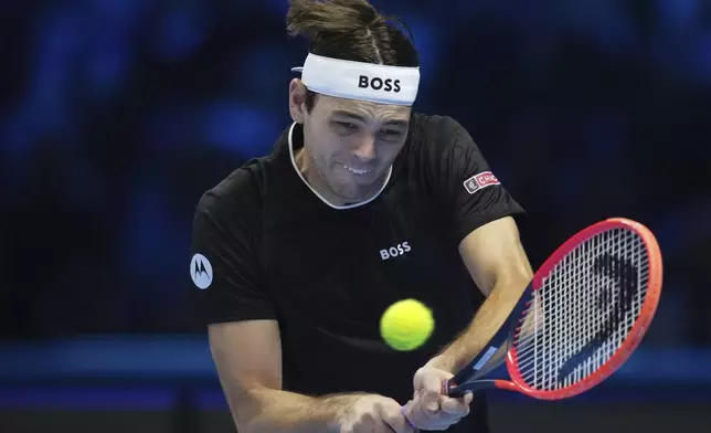 United States' Taylor Fritz returns the ball to Russia's Daniil Medvedev during their singles tennis match of the ATP World Tour Finals at the Inalpi Arena, in Turin, Italy, Sunday, Nov. 10, 2024. (AP Photo/Antonio Calanni)