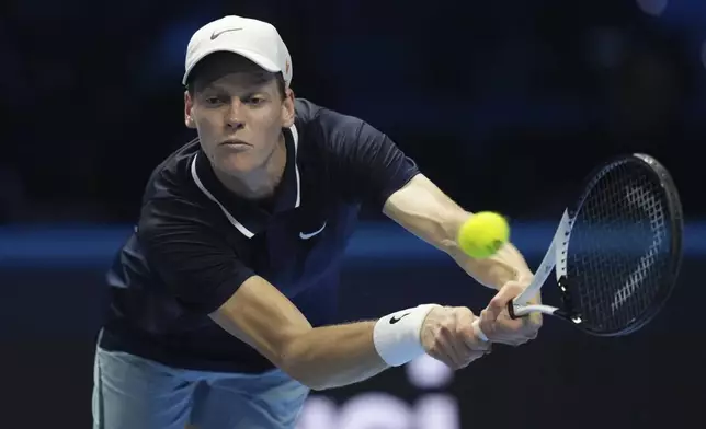 Italy's Jannik Sinner returns the ball to Australia's Alex de Minaur during their singles tennis match of the ATP World Tour Finals at the Inalpi Arena, in Turin, Italy, Sunday, Nov. 10, 2024. (AP Photo/Antonio Calanni)