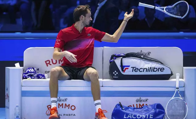 Daniil Medvedev throws a broken racket during his singles tennis match of the ATP World Tour Finals against Taylor Fritz, of the United States, at the Pala Alpitour, in Turin, Italy, Sunday, Nov. 10, 2024. (Marco Alpozzi/LaPresse via AP)