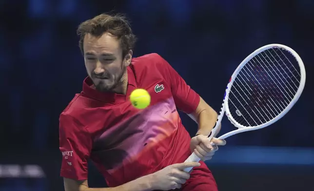 Russia's Daniil Medvedev returns the ball to Australia's Alex de Minaur during their singles tennis match of the ATP World Tour Finals at the Inalpi Arena, in Turin, Italy, Tuesday, Nov. 12, 2024. (AP Photo/Antonio Calanni)