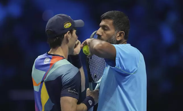 India's Rohan Bopanna, right, and Australia's Matthew Ebden talk during their doubles tennis match of the ATP World Tour Finals against Italy's Simone Bolelli and Andrea Vavassori, at the Inalpi Arena, in Turin, Italy, Monday, Nov. 11, 2024. (AP Photo/Antonio Calanni)