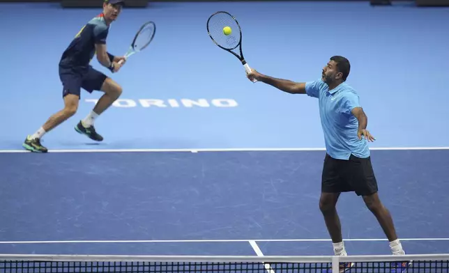 India's Rohan Bopanna, right, and Australia's Matthew Ebden return the ball to Italy's Simone Bolelli and Andrea Vavassori during their doubles tennis match of the ATP World Tour Finals at the Inalpi Arena, in Turin, Italy, Monday, Nov. 11, 2024. (AP Photo/Antonio Calanni)