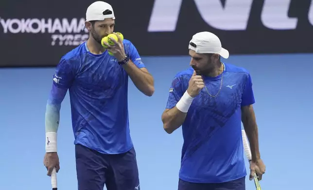 Italy's Simone Bolelli and Andrea Vavassori talk during their doubles tennis match of the ATP World Tour Finals against India's Rohan Bopanna and Australia's Matthew Ebden, at the Inalpi Arena, in Turin, Italy, Monday, Nov. 11, 2024. (AP Photo/Antonio Calanni)