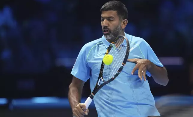 India's Rohan Bopanna returns the ball with his teammate Australia's Matthew Ebden to Italy's Simone Bolelli and Andrea Vavassori during their doubles tennis match of the ATP World Tour Finals at the Inalpi Arena, in Turin, Italy, Monday, Nov. 11, 2024. (AP Photo/Antonio Calanni)