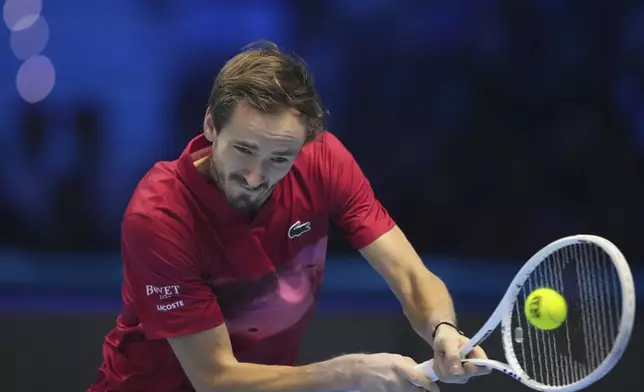 Russia's Daniil Medvedev returns the ball to Australia's Alex de Minaur during their singles tennis match of the ATP World Tour Finals at the Inalpi Arena, in Turin, Italy, Tuesday, Nov. 12, 2024. (AP Photo/Antonio Calanni)