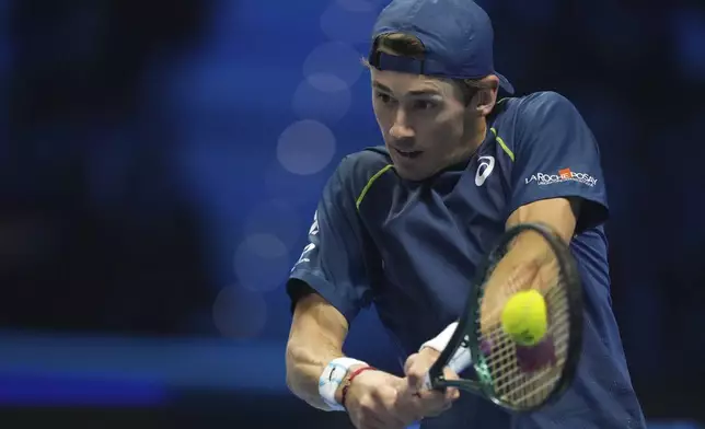 Australia's Alex de Minaur returns the ball to Russia's Daniil Medvedev during their singles tennis match of the ATP World Tour Finals at the Inalpi Arena, in Turin, Italy, Tuesday, Nov. 12, 2024. (AP Photo/Antonio Calanni)