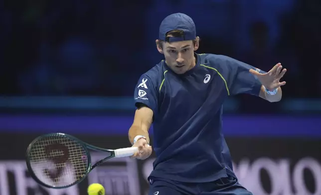 Australia's Alex de Minaur returns the ball to Russia's Daniil Medvedev during their singles tennis match of the ATP World Tour Finals at the Inalpi Arena, in Turin, Italy, Tuesday, Nov. 12, 2024. (AP Photo/Antonio Calanni)