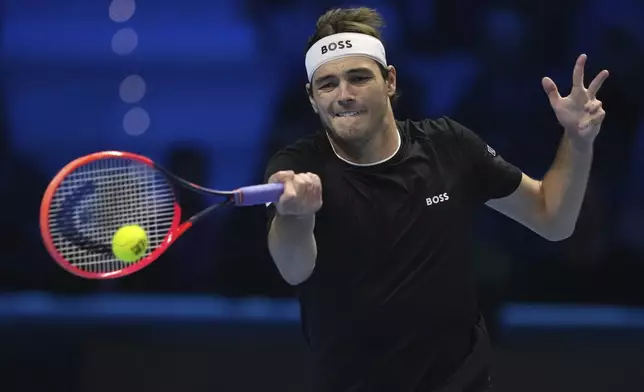 United States' Taylor Fritz returns the ball to Italy's Jannik Sinner during their singles tennis match of the ATP World Tour Finals at the Inalpi Arena, in Turin, Italy, Tuesday, Nov. 12, 2024. (AP Photo/Antonio Calanni)