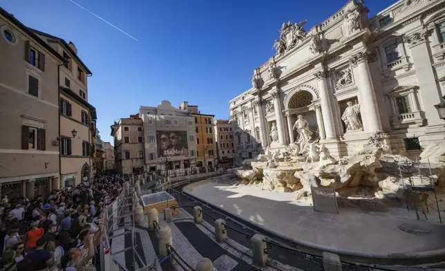 A small pool is seen in front of the Trevi Fountain to allow tourists to throw their coins in it, as the fountain has been emptied to undergo maintenance work that will last until around September 2025, in Rome, Friday, Nov. 1, 2024. (AP Photo/Andrew Medichini)