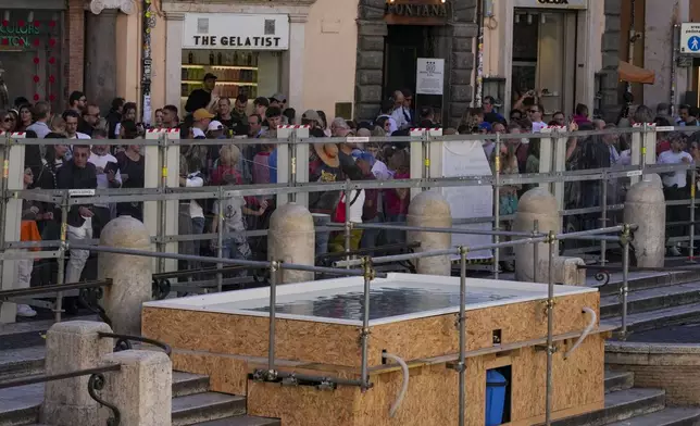 A small pool placed in front of the Trevi Fountain to allow tourists to throw their coins in it, as the fountain has been emptied to undergo maintenance work that will last until around September 2025, in Rome, Friday, Nov. 1, 2024. (AP Photo/Andrew Medichini)