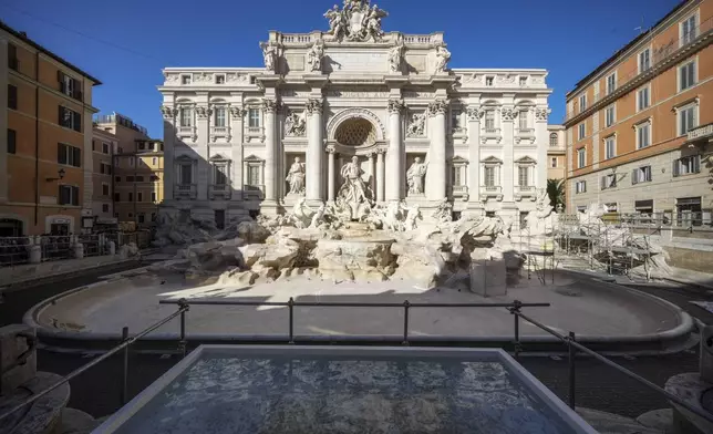 A small pool is seen in front of the Trevi Fountain to allow tourists to throw their coins in it, as the fountain has been emptied to undergo maintenance work that will last until around September 2025, in Rome, Friday, Nov. 1, 2024. (AP Photo/Andrew Medichini)