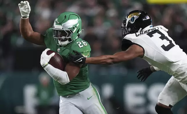 Philadelphia Eagles running back Saquon Barkley (26) is stopped by Jacksonville Jaguars cornerback Tyson Campbell (3) during the first half of an NFL football game Sunday, Nov. 3, 2024, in Philadelphia. (AP Photo/Matt Slocum)